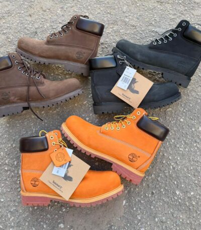 Timberland Classic Waterproof Boots in brown, black, and orange, featuring rugged design and waterproof construction for outdoor enthusiasts.