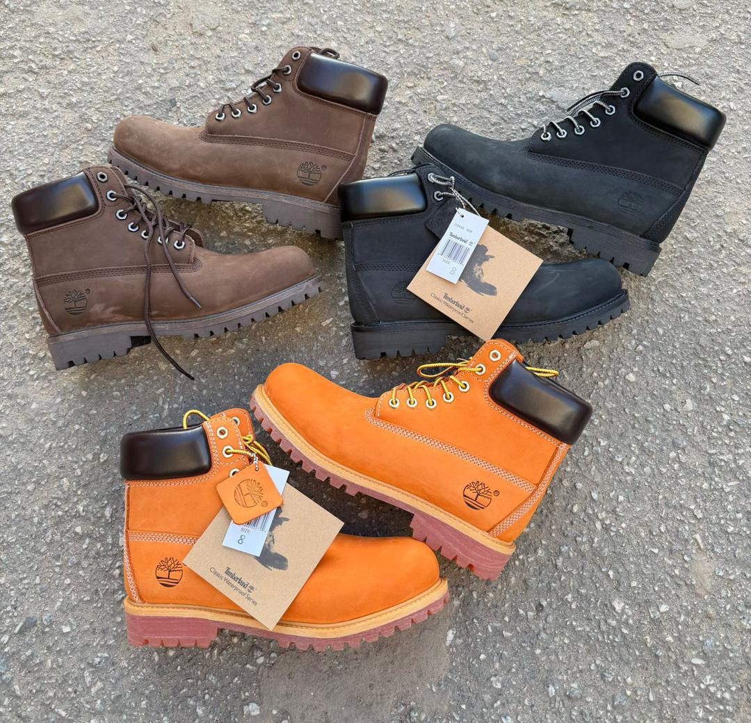 IMG-20260425-WA0010 Timberland Classic Waterproof Boots in brown, black, and orange, featuring rugged design and waterproof construction for outdoor enthusiasts.