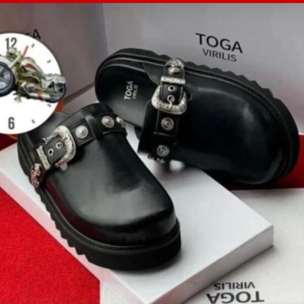 A pair of black leather clogs with silver buckles on a white box, showcasing the Toga Virilis logo, perfect for luxury footwear enthusiasts.