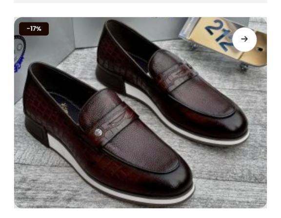 A pair of dark brown leather penny loafers with white soles, showcasing exceptional craftsmanship and style.