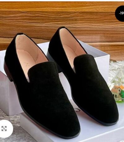 A pair of black suede loafers on a white shoe box, showcasing luxurious comfort and style.