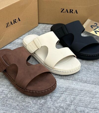 A close-up view of Zara's two-strap buckle sandals in brown, beige, and black, showcasing the luxurious design and premium materials.