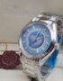 A luxurious Omega Seamaster World Time watch with a blue dial and stainless steel band, presented in its elegant box with a red tag.