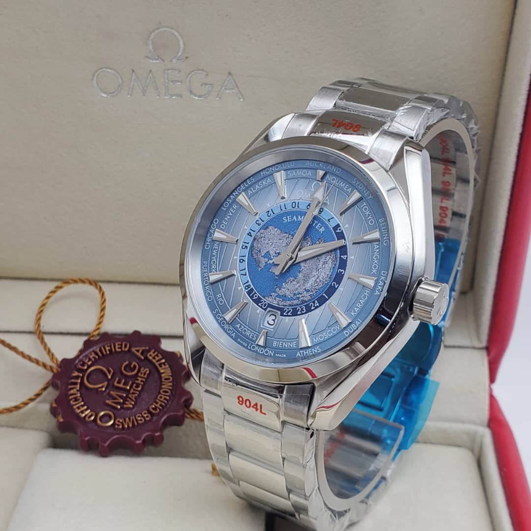IMG-20260612-WA0007 A luxurious Omega Seamaster World Time watch with a blue dial and stainless steel band, presented in its elegant box with a red tag.