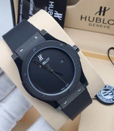 A close-up shot of a Hublot Big Bang watch with a black ceramic case and band, showcasing its sleek design and Swiss made movement.