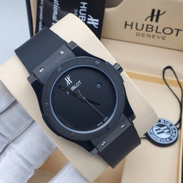A close-up shot of a Hublot Big Bang watch with a black ceramic case and band, showcasing its sleek design and Swiss made movement.