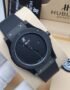 A close-up shot of a Hublot Big Bang watch with a black ceramic case and band, showcasing its sleek design and Swiss made movement.