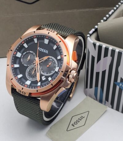 A luxurious Fossil watch with a rose gold case, black dial, and green strap, exuding high-end style and sophistication.