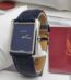 A luxurious Cartier Tank Solo watch with a navy blue dial and leather strap, exuding sophistication and refinement.