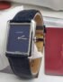 A luxurious Cartier Tank Solo watch with a navy blue dial and leather strap, exuding sophistication and refinement.