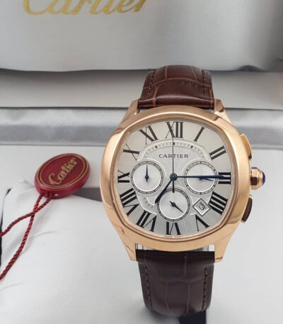 A luxurious Cartier rose gold watch with brown leather strap, showcased in its elegant box with red tag.