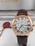 A luxurious Cartier rose gold watch with brown leather strap, showcased in its elegant box with red tag.