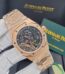 A close-up view of a rose gold Audemars Piguet Royal Oak Skeleton watch with an exposed movement, held by a gloved hand against a backdrop of the brand's packaging.
