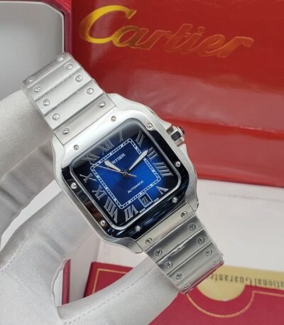 A sleek Cartier watch with a blue face and silver band, resting on a white glove with the Cartier box in the background.