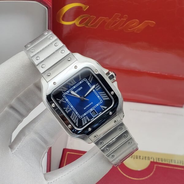 A sleek Cartier watch with a blue face and silver band, resting on a white glove with the Cartier box in the background.