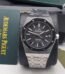 Audemars Piguet luxury watch with black dial and stainless steel band, presented in its original box and packaging.