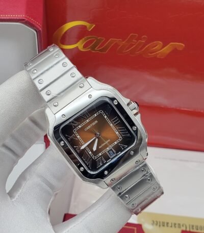 A luxurious Cartier watch with a silver band and brown face, held by a gloved hand, showcasing high-end style and sophistication.