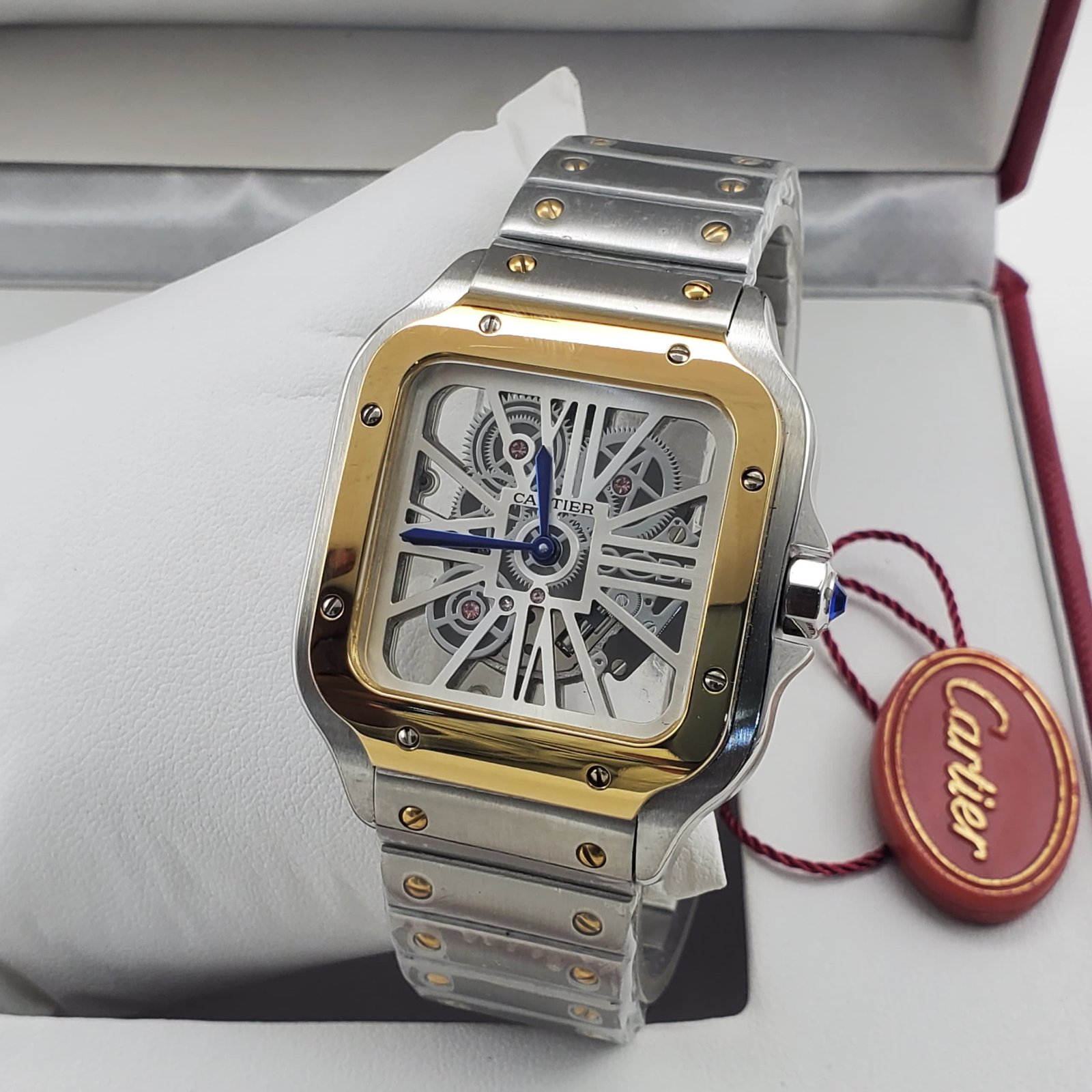 root A luxurious Cartier watch with a skeleton face, gold and silver tones, and a leather tag, exuding high-end sophistication.