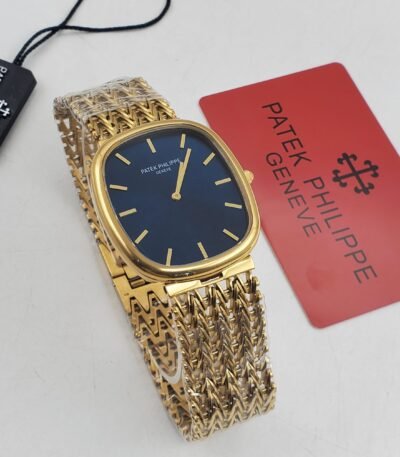A luxurious gold Patek Philippe watch with a blue face and gold band, accompanied by a red Patek Philippe card and black tag.