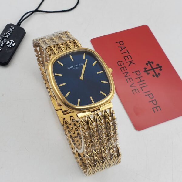 A luxurious gold Patek Philippe watch with a blue face and gold band, accompanied by a red Patek Philippe card and black tag.
