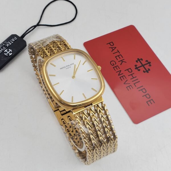 A luxurious Patek Philippe watch with a gold band and white face, accompanied by a red card and black tag, showcasing its high-end craftsmanship.