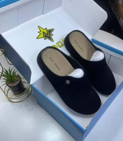 A pair of black loafers nestled in a white and blue shoe box, exuding luxury and comfort.