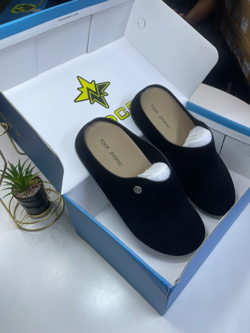 WhatsApp Image 2026-09-20 at 10.57.57 AM (1) A pair of black loafers nestled in a white and blue shoe box, exuding luxury and comfort.
