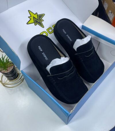 A pair of luxurious black loafers nestled in a stylish box, exuding high-end quality and comfort.