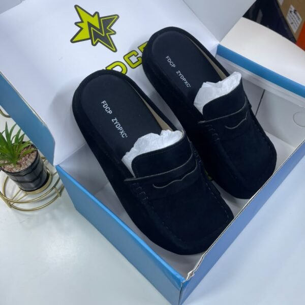 A pair of luxurious black loafers nestled in a stylish box, exuding high-end quality and comfort.